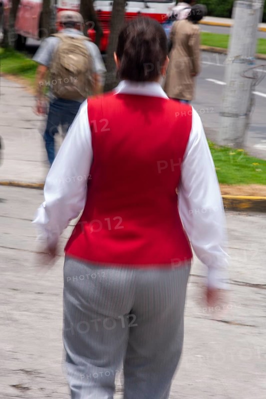Woman walking in street, Photo with motion blur, City of Quito, Pichincha province, Ecuador, South America