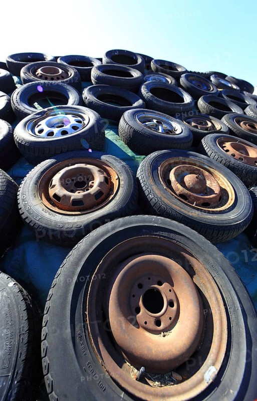 Old wheels, rims and tyres, used here to weigh down the cover of an agricultural silo
