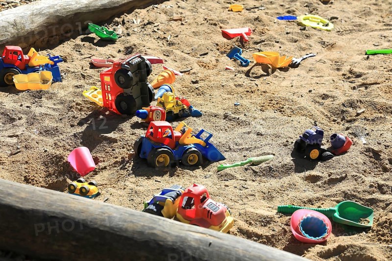 Playground, sandpit with plastic toys, vehicles, shovel