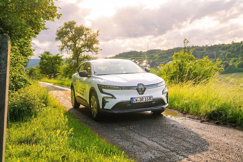 Car on a sunny path through a green, cloudy landscape, Deer E- CarSharing, Renault Megane electric car, Calw, Black Forest, Germany