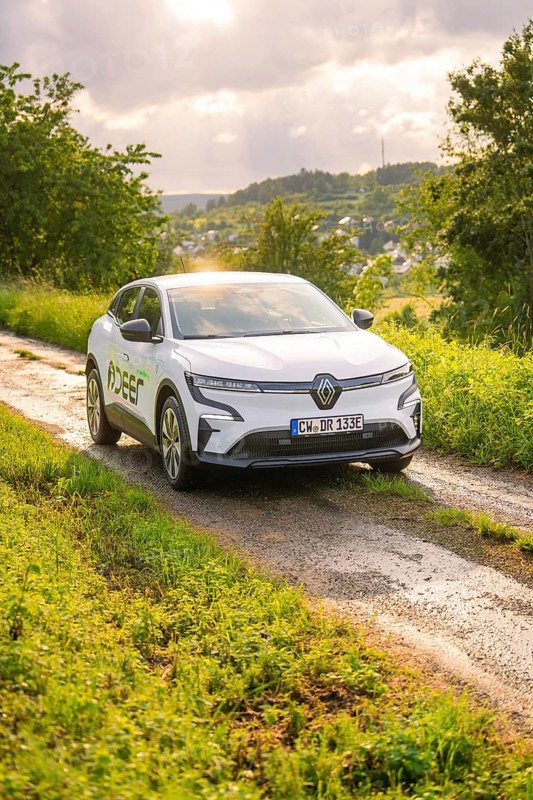 Car on a rural road surrounded by trees and a wide landscape, Deer E- CarSharing, Renault Megane electric car, Calw, Black Forest, Germany