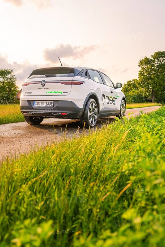 Rear view of a Renault on a country road surrounded by meadows, Deer E- CarSharing, Renault Megane electric car, Calw, Black Forest, Germany