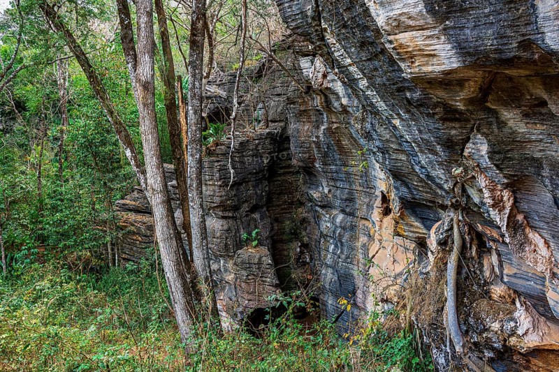Vertical rocky formation between the trees of the tropical forest in Lapinha da Serra, Minas Gerais, Lapinha da Serra, Minas Gerais, Brazil