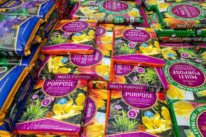 Multi Purpose compost bags stacked up at Lowden garden centre, Wiltshire, England, UK