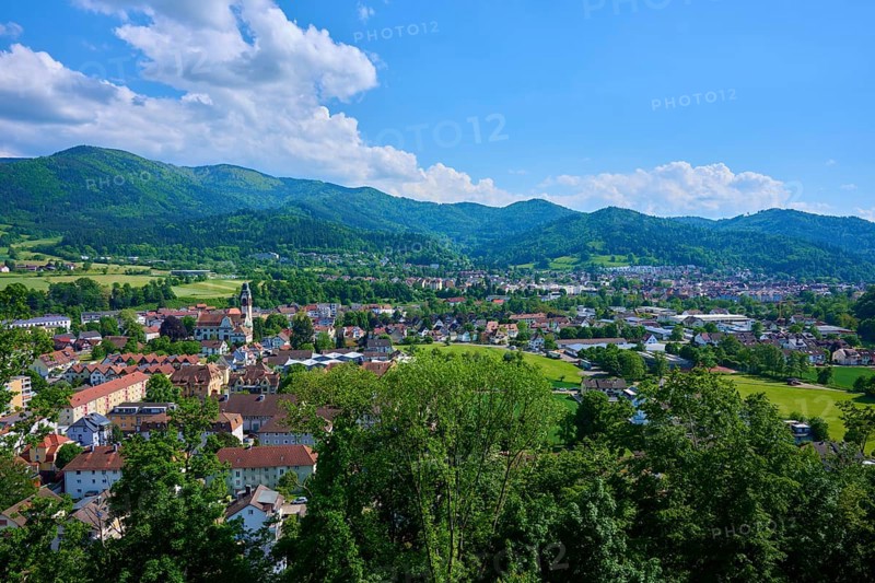 View of a district town surrounded by green hills under a cloudy blue sky, Waldkirch, Breisgau, Black Forest, Baden-Württemberg, Germany