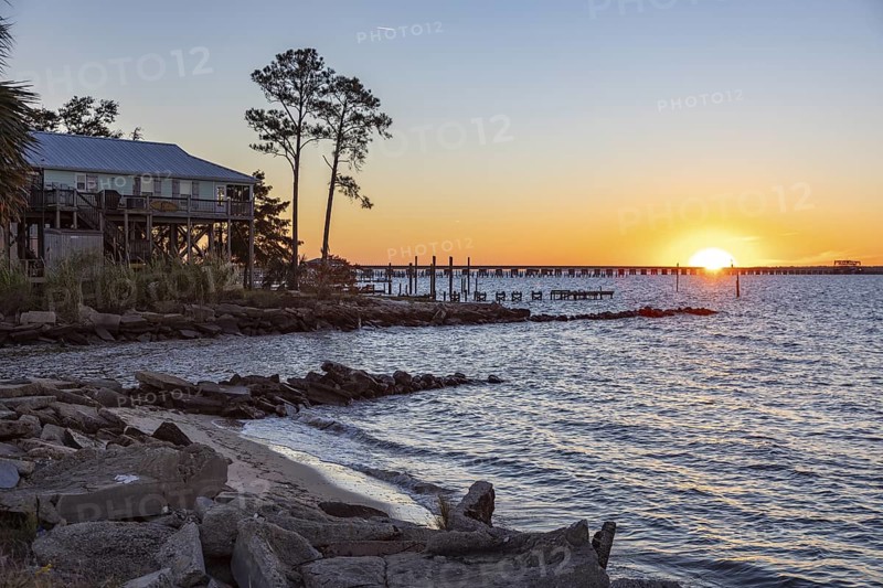 Sunset over the railroad bridge across Bay of Saint Louis from Henderson Point in Pass Christian, Mississippi