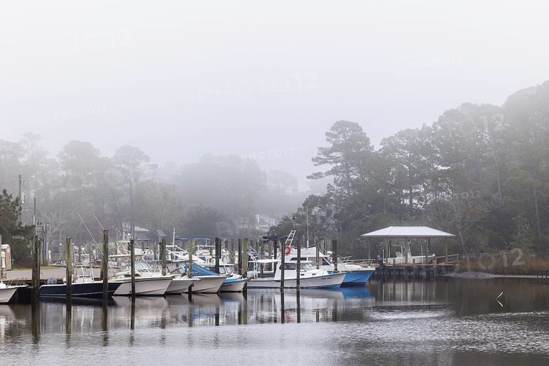 Private fishing boats in the harbor at Ocean Springs, Mississippi on a foggy morning