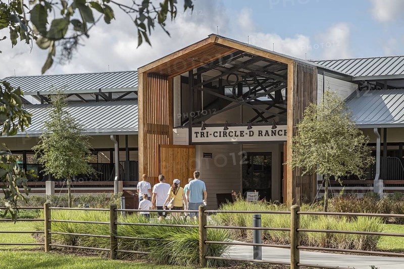 Family entering the Tri-Circle-D Ranch horse stables in the Fort Wilderness Campground and Resort at Disney World in Orlando, Florida