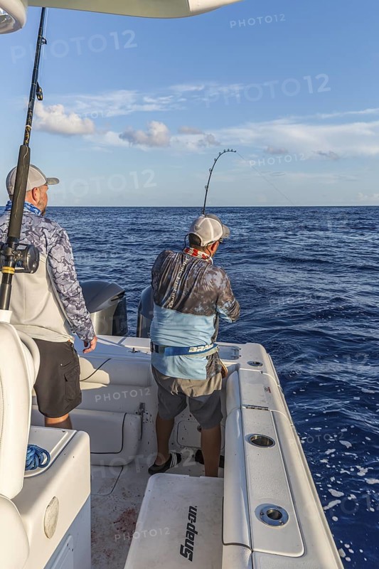 Offshore fisherman reeling in a fish in the Gulf of Mexico
