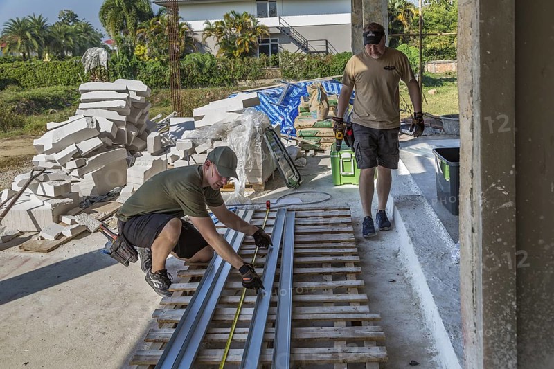 American men preparing metal studs while volunteering to help build the Grace Language School and Baan Athitaan Church building in Chiang Rai, Thailand