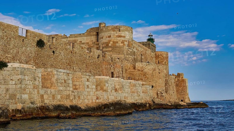 Castello Maniace, Maniace sea fortress, old castle by the sea under a blue sky, surrounded by stone walls, boat trip around the island of Ortigia, Isola di Ortigia, Syracuse, Sicily, Italy
