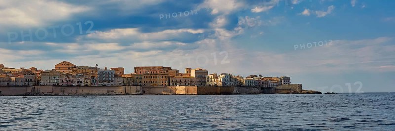 Historic city scenery on the coast under a slightly cloudy sky, boat trip around the island of Ortigia, Isola di Ortigia, Syracuse, Sicily, Italy