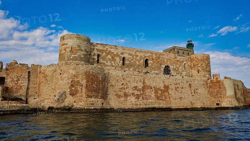 Castello Maniace, Maniace sea fortress, medieval castle with lighthouse by the sea under a blue sky, boat trip around the island of Ortigia, Isola di Ortigia, Syracuse, Sicily, Italy