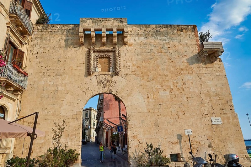 Historic stone city gate with visible road through the arch, Ortigia Island, Isola di Ortigia, Historic Old Town, Syracuse, Sicily, Italy
