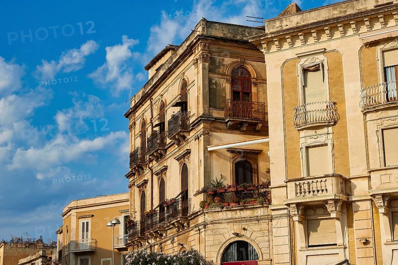 Close-up view of historic buildings with balconies and windows under blue sky, Ortigia Island, Isola di Ortigia, Historic Centre, Syracuse, Sicily, Italy