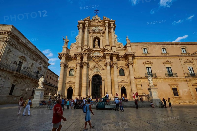 Cathedral of Syracuse, Large cathedral on a square with people and statues under a blue sky, Ortigia Island, Isola di Ortigia, Historic old town, Syracuse, Sicily, Italy