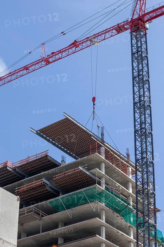 Detroit, Michigan - Construction of the 25-story JW Marriott Detroit Water Square hotel. The framework for a new floor is lowered into place, cement will then be poured over it