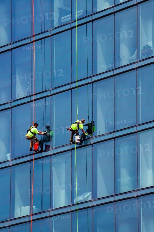 Detroit, Michigan - Window washers at the 25-story Residences Water Square luxury apartment building