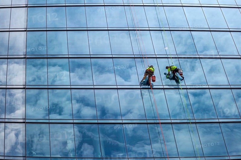 Detroit, Michigan - Window washers at the 25-story Residences Water Square luxury apartment building