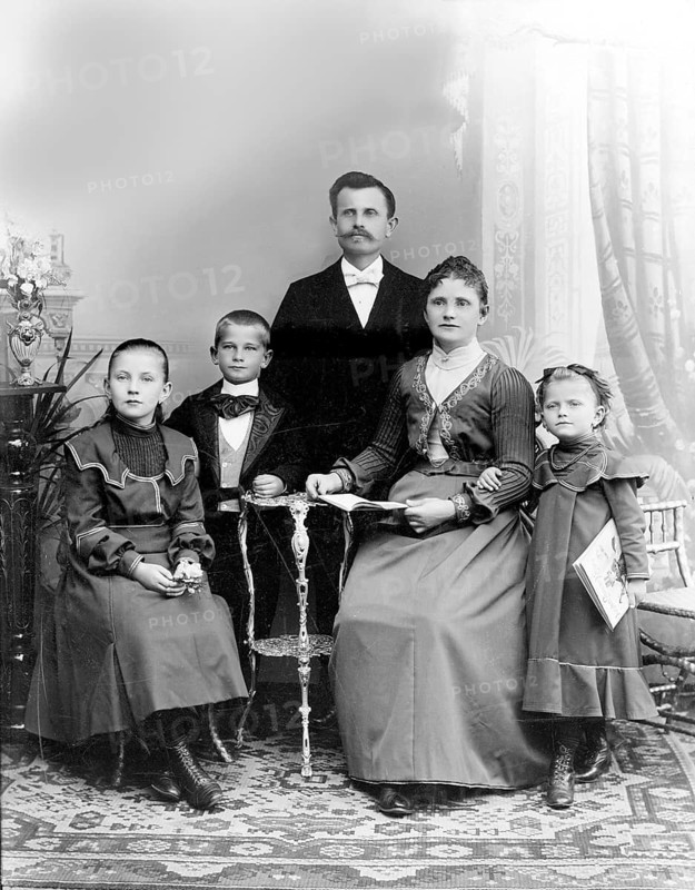 Father Mother Boy Girl, 1920s, A formal family portrait with parents and three children in traditional dress, Historical photograph