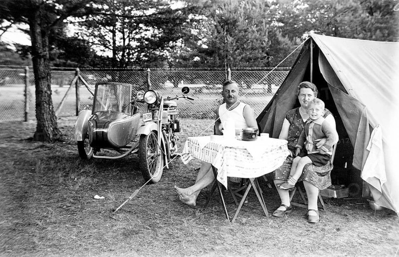 Camping family, 1930s, family camping next to a tent and motorbike, relaxed outdoor atmosphere, historical photo