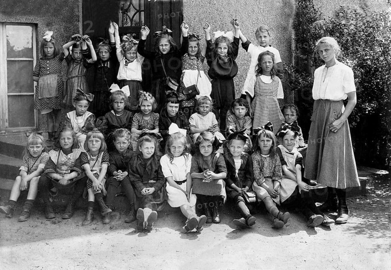 Group of girls in the 1930s, ca. 1930, A large group of children and a teacher are happy and posing outside, historical photo