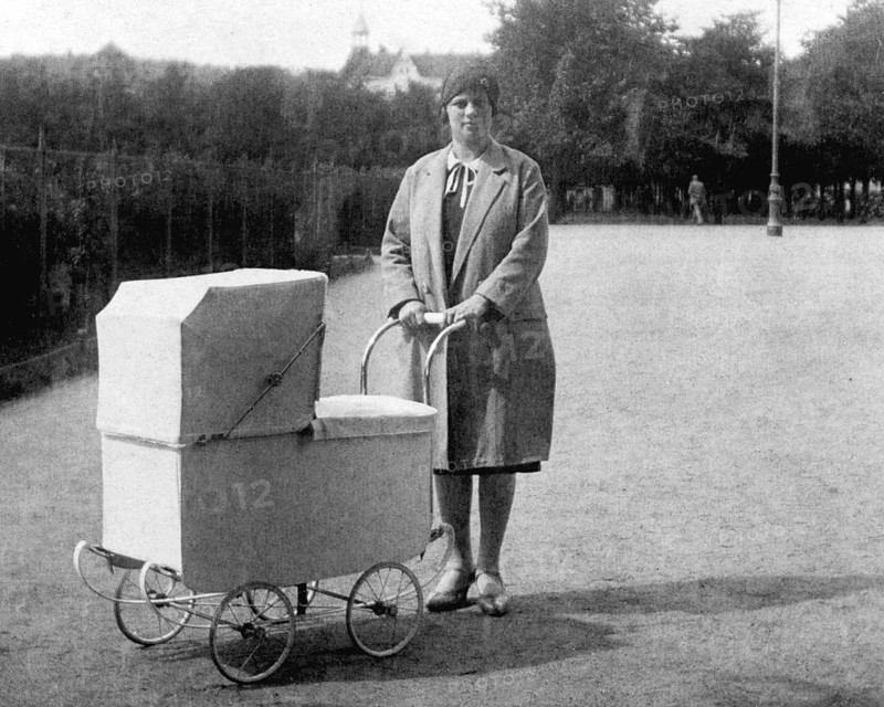 Woman with pram, 1930s, Woman with pram in a park, historical black and white photo with vintage atmosphere, Historical photo