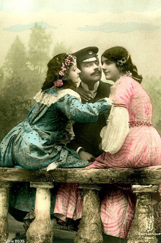 Man with 2 woman, 1920, Two woman in colourful dresses and a man in uniform sitting in conversation, Historical photo