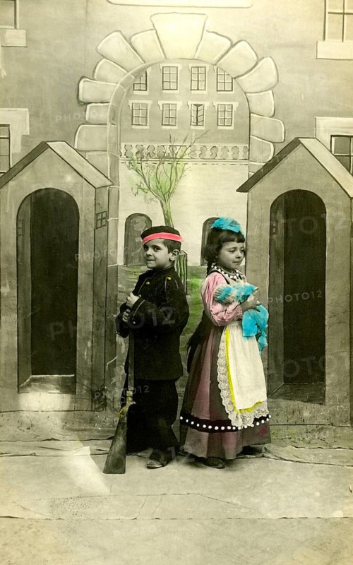 2 children dressed up, 1920, Two children in costumes with toy gun, in front of a painted scenery, vivid colours, Historical photo