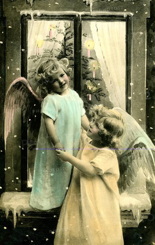 2 children as angels, 1920, Two children dressed as angels dancing in front of a decorated window, Historical photo