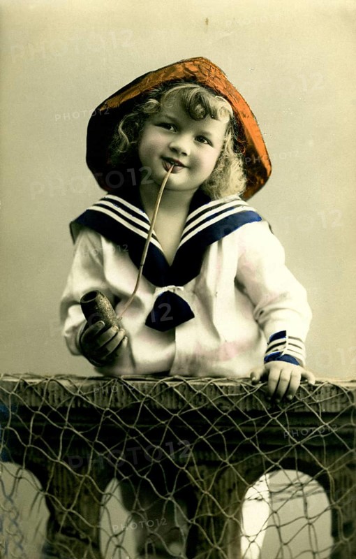 Girl in sailor look, 1920s, A boy in sailor clothes with pipe poses smiling, Historical photo