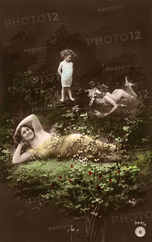 Woman and children posing in the forest, 1910s, Two woman and a child in a flowery meadow with a surreal touch, Historic photograph