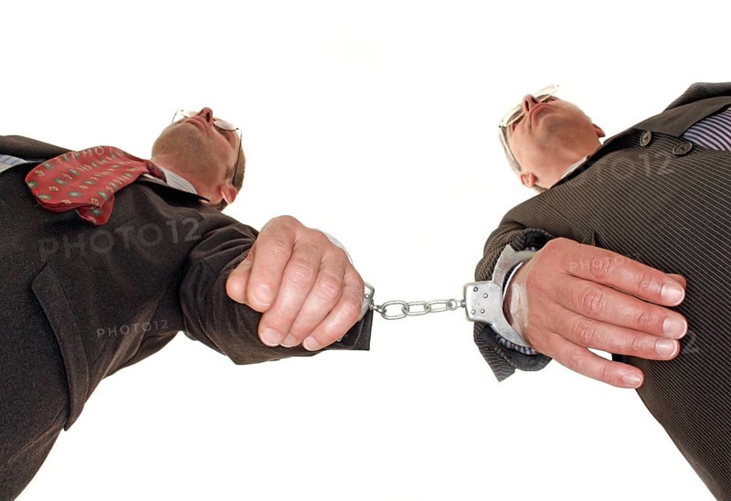 Businessman, two, handcuffs, suit and tie, Berlin, Germany, low angle shot of two men in handcuffs as if they were bound or trapped, historical photo