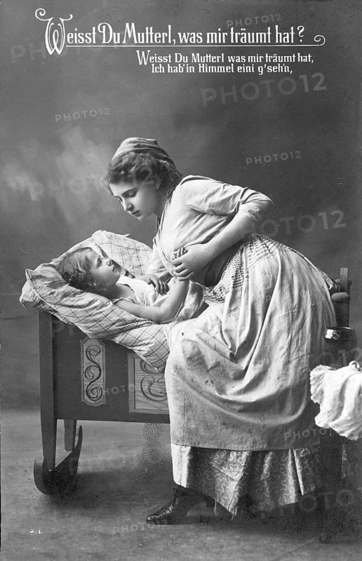 Mother with child, 1920s, A mother bends lovingly over her child in a beautiful cradle, Historical photo