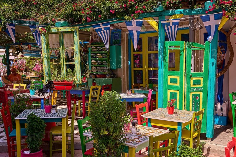 Colourfully decorated taverna with open doors and plants, summery and friendly atmosphere, Platia Diagora, Kos Town, Kos, Dodecanese, Greek Islands, Greece