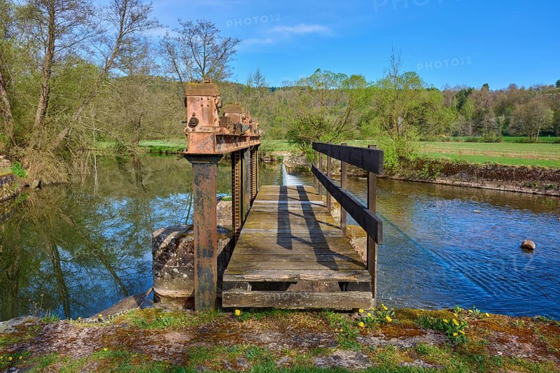 Wooden footbridge over a body of water in a natural setting with trees in the background, spring, Obersinn, Sinntal, Spessart, Bavaria, Germany