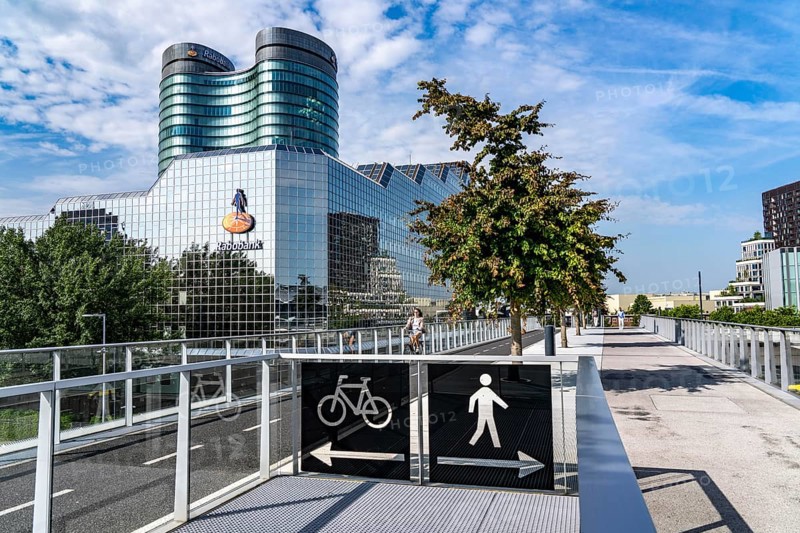 The Moreelsebrug, pedestrian and cyclist bridge over the tracks of Utrecht Centraal, Central Station, planted with trees, Rabobank building, Netherlands