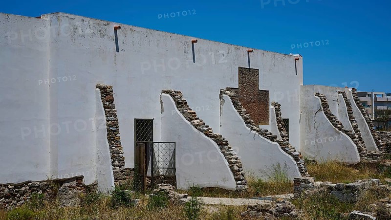 ©Udo Rein, White antique building with exposed stone walls under a blue sky, exterior view, Casa Romana, Kos Town, Kos, Dodecanese, Greek Islands, Greece