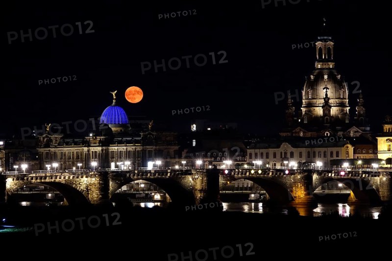 Glowing strawberry moon on 11 June 2025 over the old town of Dresden, Saxony, Germany