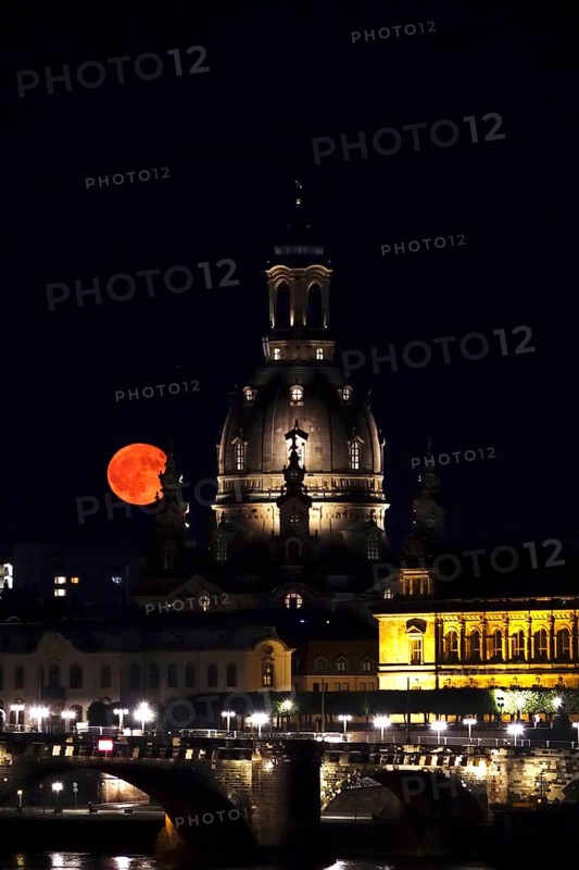 Glowing strawberry moon on 11 June 2025 over the Church of Our Lady Dresden, Saxony, Germany