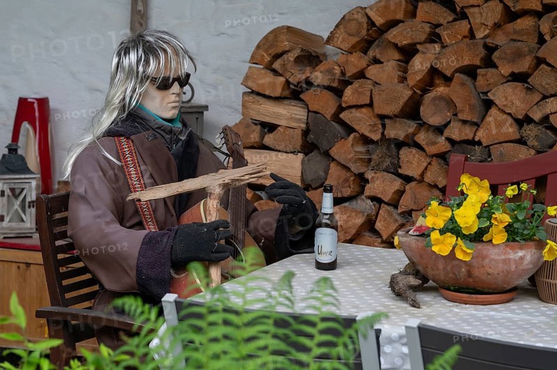 Sitting mannequin at a garden table, Bavaria, Germany