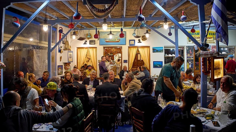 People dining in a cosy restaurant with traditional decoration, Skala, harbour, Gründonnertsga, Megali Pempti, Ouzerie, Patmos, Dodecanese, Greek Islands, Greece