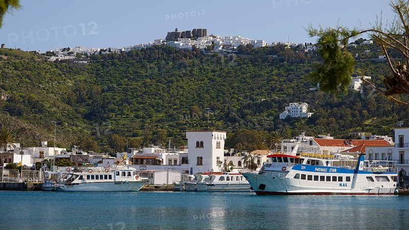 Harbour with ferries in front of green mountains and blue sea, town on the shore, Skala, harbour, Chora, Patmos, Dodecanese, Greek Islands, Greece