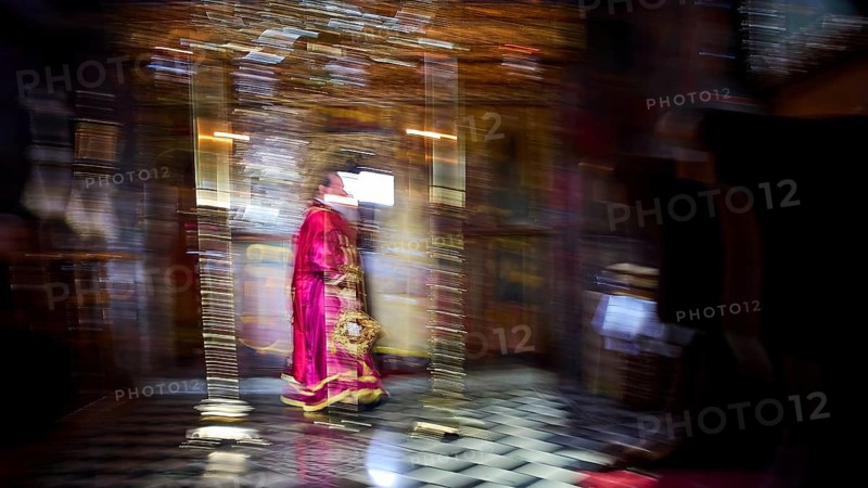 Zoodochou Pigis Monastery, Blurred image of a priest in red robes in a gold-decorated church interior, Church, Chora, World Heritage Site 1999, Patmos, Dodecanese, Greek Islands, Greece