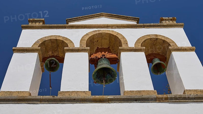 Cross-domed church of Panagia Diasosousan, white bell tower with three bells against a clear sky, church, Chora, World Heritage Site 1999, Patmos, Dodecanese, Greek Islands, Greece