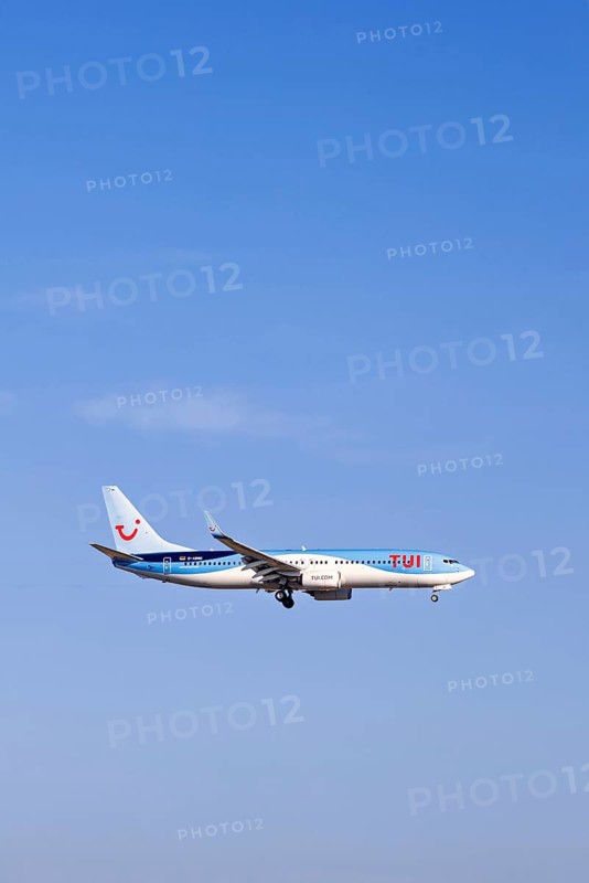 Passenger plane from Tui travel company flying on a blue sky, Mallorca, Spain
