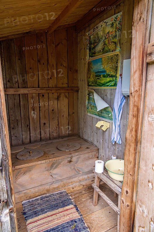 Interior of an old idyllic wooden outhouse for two in the swedish countryside, Sweden