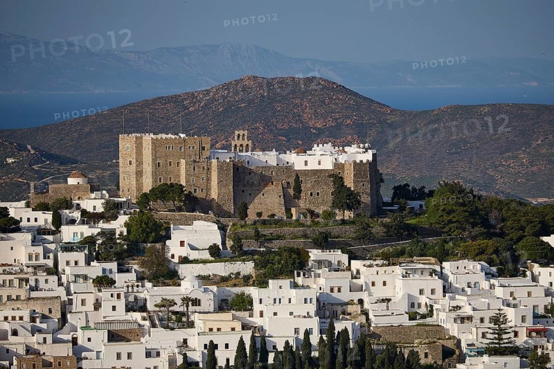 View of a castle above white houses, framed by mountains and the sea, Monastery of St John the Theologian, Monastery of St John the Theologian, World Heritage Site 1999, Chora, Patmos, Dodecanese, Greek Islands, Greece