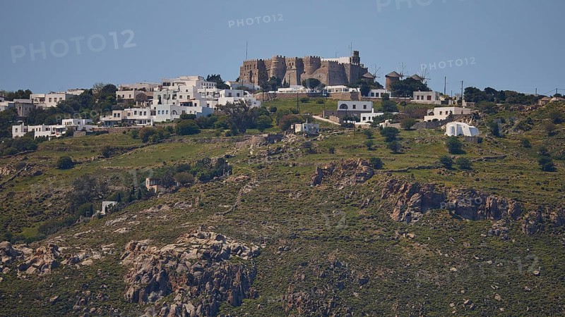 Village on a hill with stone houses and green landscape under a clear sky, Monastery of St John the Theologian, Monastery of St John the Theologian, World Heritage Site 1999, Chora, Patmos, Dodecanese, Greek Islands, Greece