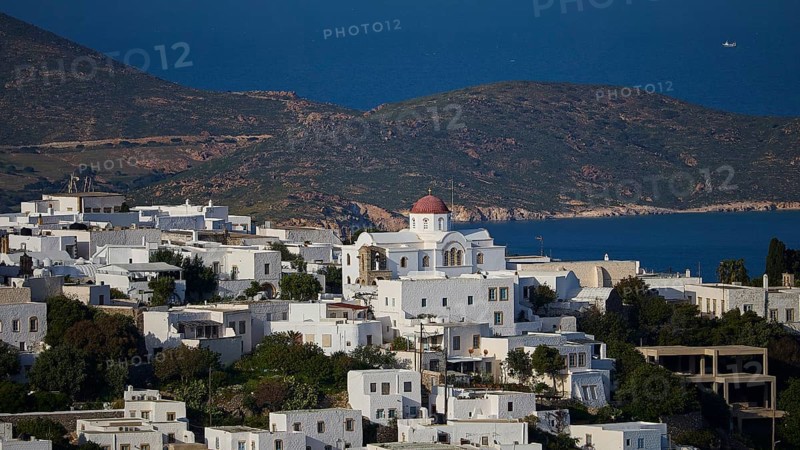 Whitewashed church with red roof in front of a coastal landscape and blue sea, World Heritage Site 1999, Chora, Patmos, Dodecanese, Greek Islands, Greece